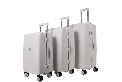 Three hard-shell spinner suitcases in a light gray or off-white color, arranged by size from left to right, with telescoping handles extended, on a plain white background.
