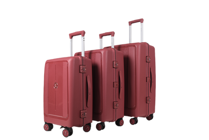 Three-piece hardshell luggage set in a dusty rose red color, featuring telescoping handles, spinner wheels, and a small circular metal emblem on the front of each suitcase, shown against a plain white background.