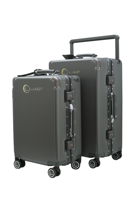 Two gray suitcases with wheels and handles on a white background