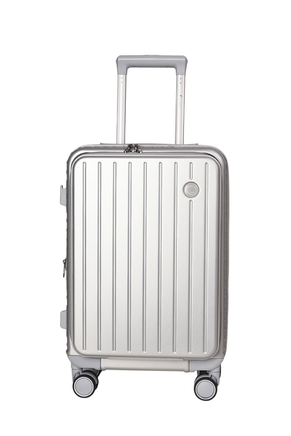 A silver aluminum spinner suitcase with a telescopic handle extended, featuring a vertical ribbed design and a small circular badge on the front, set against a plain white background.