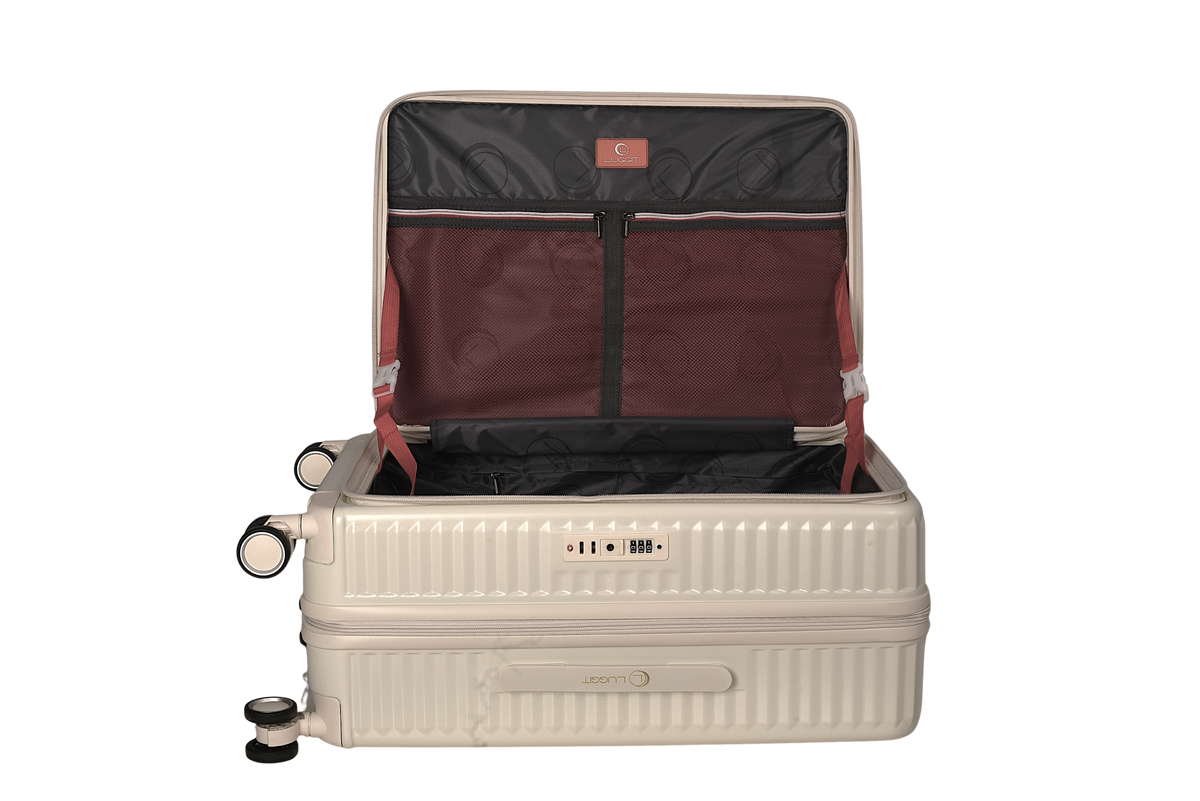 An open hard-shell carry-on suitcase in a light beige/cream color, showing its interior. The inside features a dark gray organizer panel with circular cutouts, a burgundy fabric lining, and red straps.