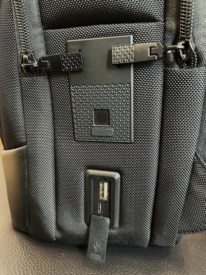 Close-up of a gray backpack with a visible brand logo on a neutral background
