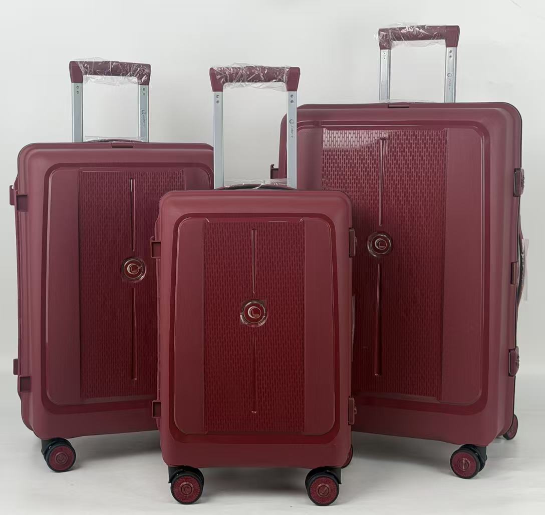 Three maroon suitcases of different sizes on a light gray background