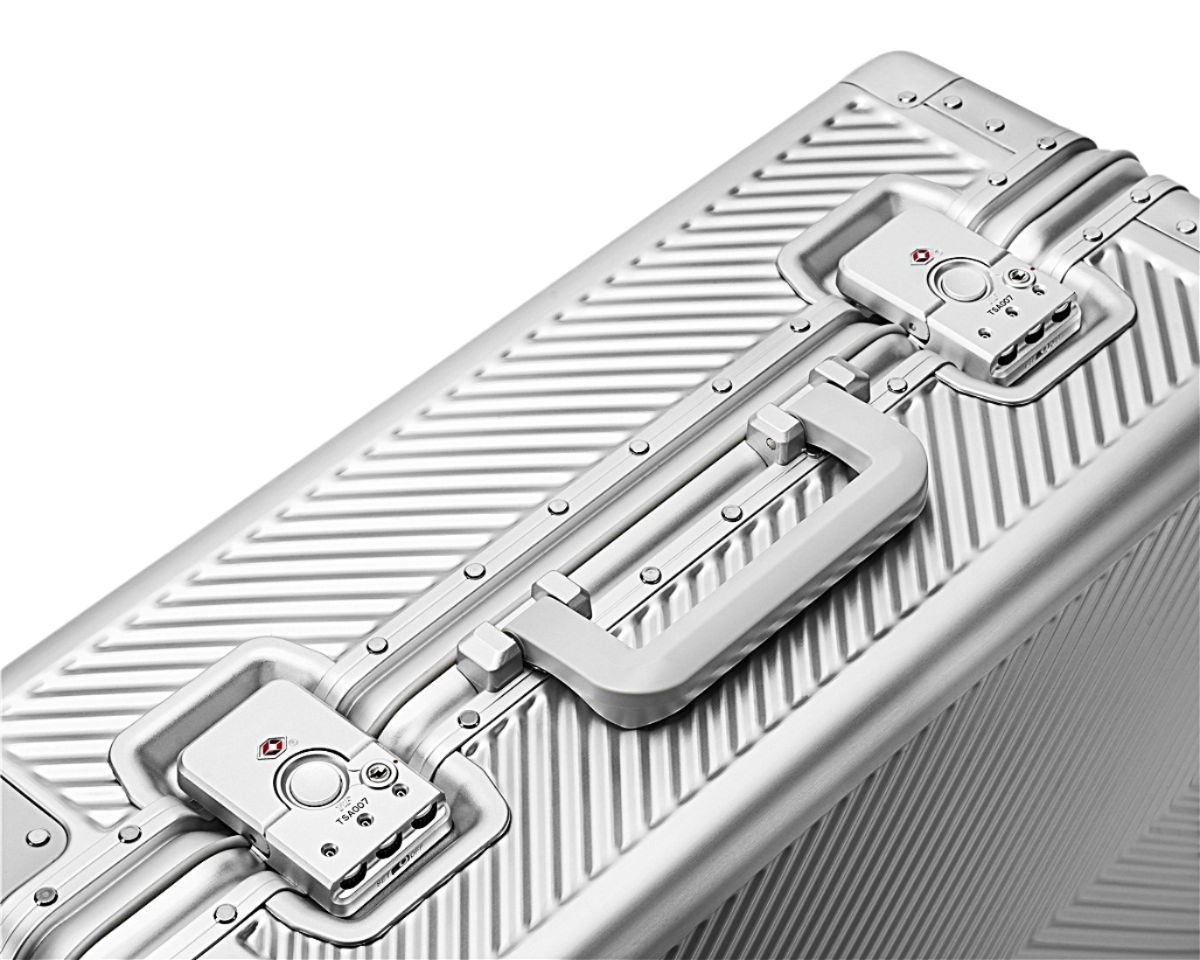 Silver suitcase with a textured luggit