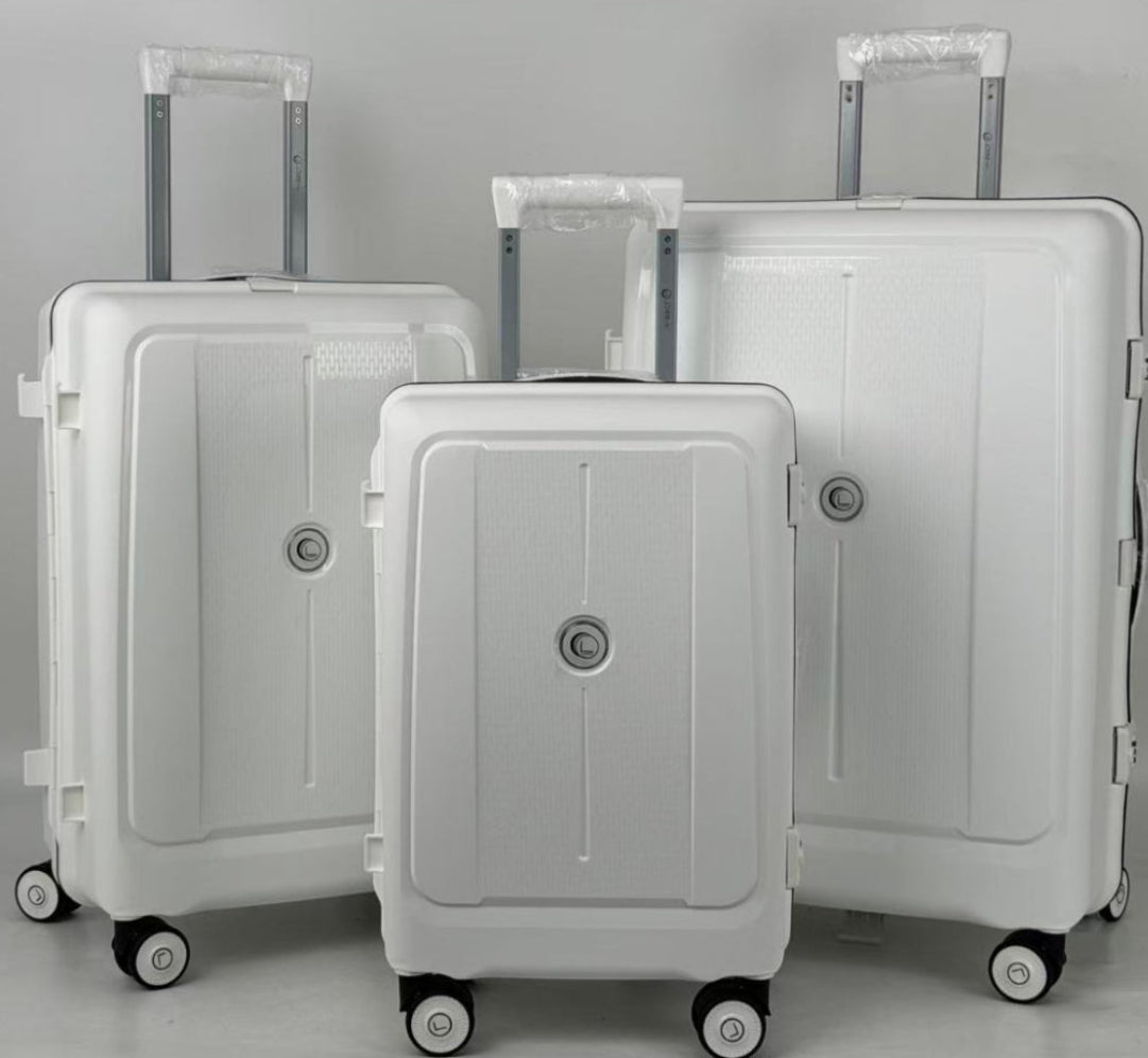 Three white suitcases of different sizes on a gray background
