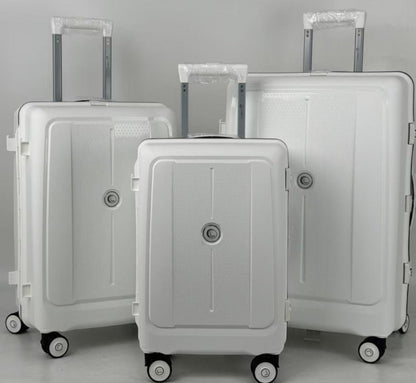 Three white suitcases of different sizes on a gray background