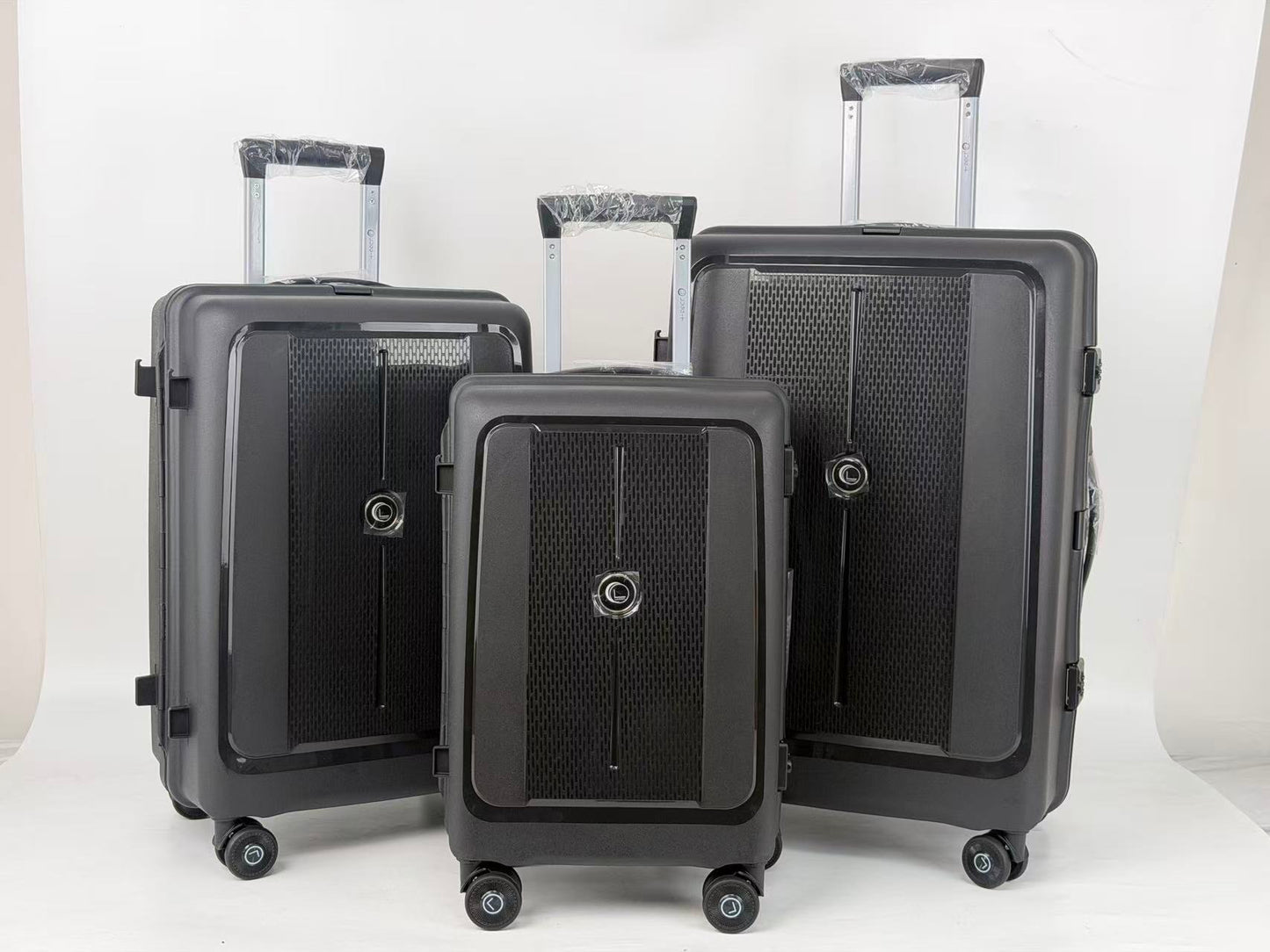 Set of black suitcases of different sizes on a white background