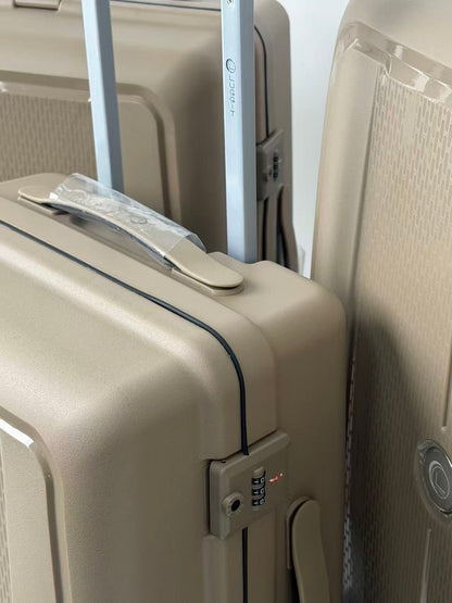 Close-up of beige suitcases with a focus on a suitcase handle and lock.