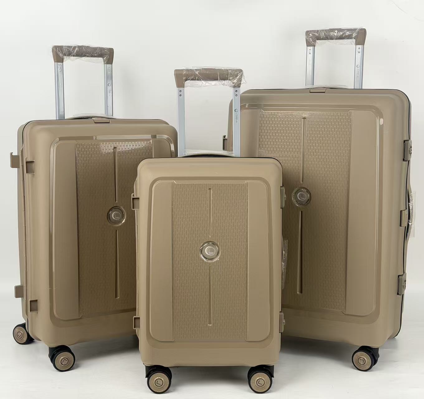 Three beige suitcases of different sizes on a white background