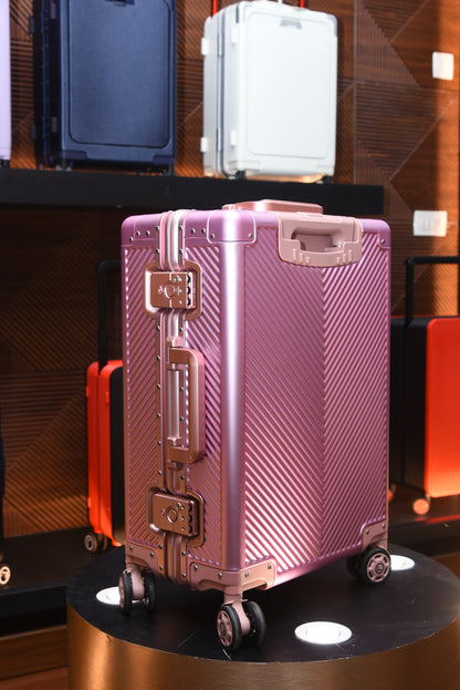 Pink suitcase with a textured surface on a reflective surface